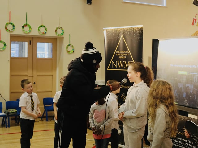 Black Paddy interviewing one young Model Primary School pupil.
