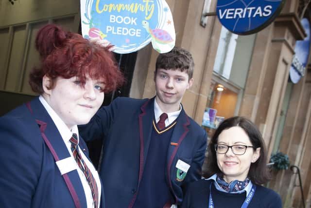 Eileen Hunter from Veritas on Shipquay Street pictured making a donation on Friday morning.