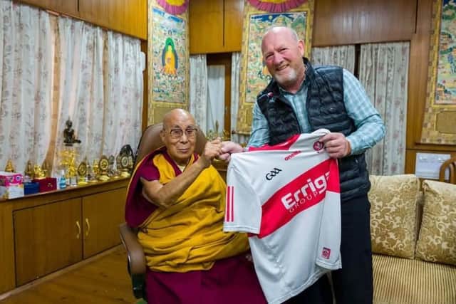 Greg McLaughlin presenting the Dalai Lama with an Oak Leaf jersey.