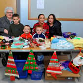 Ann McKeever (left) with Jane Breslin, Kayleigh Breslin, Cael, Quinn and Lenny at her stall at the Christmas Craft Fair held in the Galliagh Community Centre in 2022. Photo: George Sweeney. DER2250GS – 74