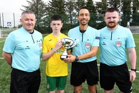 Match referee Jose Fernandes presenting the O'Neills Foyle Cup under-13's Cup to Donegal Underage League captain Eoghan O'Neill at the Waterside Shared Village on Saturday. Included are Paul and Ethan McLaughlin, assistant referees.
