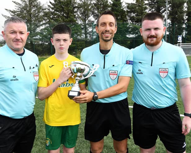 Match referee Jose Fernandes presenting the O'Neills Foyle Cup under-13's Cup to Donegal Underage League captain Eoghan O'Neill at the Waterside Shared Village on Saturday. Included are Paul and Ethan McLaughlin, assistant referees.