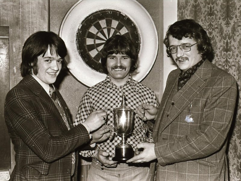 Thomas Wade (centre) captain of the winning Harbour Team being presented with the Irish Bonding Trophy at the Capitol Bar, Spencer Road by Eddie McCallion (right), Vintners' Darts Association. On left is captain of the runner-up Ebrington team, Martin Bradley.