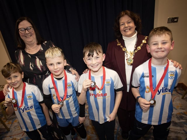 Young players from Strabane Athletic receiving their medals as runners-up in the U10 Summer Plate from the Mayor, Patricia Logue (right) and Joanna McVeigh on Friday night.