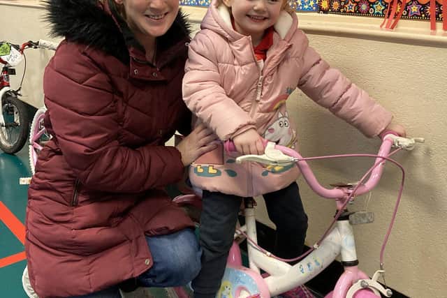 Judith Blythe with her daughter, Leah (4), who chose a new bike at the Sustrans / Life Cycle sale in the school.