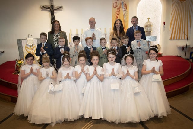 Pupils from Mrs. Cunningham's class at Greenhaw Primary School who received the Sacrament of First Holy Communion from Fr. Sean O'Donnell at St. Brigid's Church, Carnhill on Friday last. Included are Miss Coyle, teaching assistant and Mr. Sean McLaughlin, Principal. (Photo: Jim McCafferty Photography)