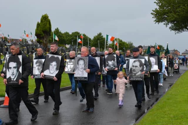 Republicans carry the portraits of volunteers killed during the conflict at a previous commemoration.