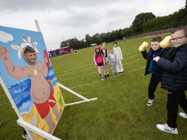 Holy Child PS teacher Mr. Lowry gets it in the face from these two P6 pupils, Kian and Shane during the Summer Fair on Friday.