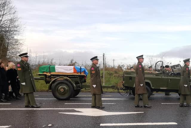 Members of the Irish Defence Forces lead Pte Rooney's funeral cortege to the cemetery at All Saints Church, Newtowncunningham.