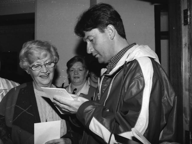 Daniel O'Donnell signs autographs.