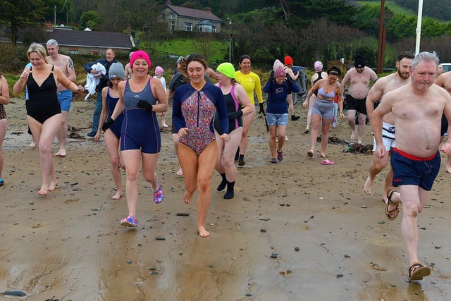 People taking part in the annual ARC Fitness New Year's Day Charity Swim at Lisfannon beach make their way into the Swilly.  Photo: George Sweeney. DER2301GS  02