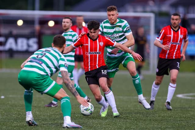 Derry City midfielder Adam O'Reilly jinks past Rovers defender Lee Grace during Monday's clash at Brandywell. Photo by Kevin Moore.