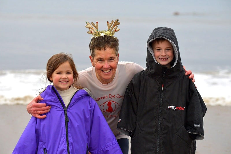 Organiser of the annual Christmas morning charity swim at Ludden beach, Buncrana, Roisin Lynch pictured with her grandchildren Erin and Flynn Laxon. Photo: George Sweeney. DER2252GS – 27