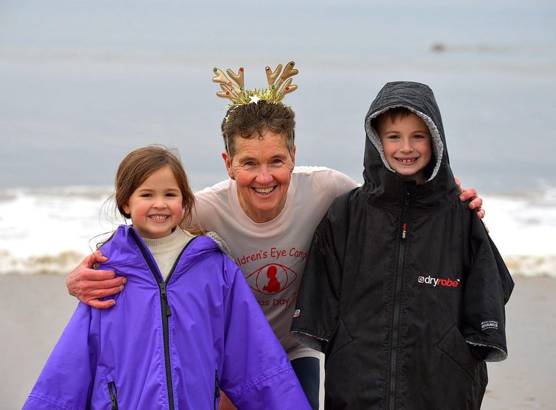 Organiser of the annual Christmas morning charity swim at Ludden beach, Buncrana, Roisin Lynch pictured with her grandchildren Erin and Flynn Laxon. Photo: George Sweeney. DER2252GS – 27