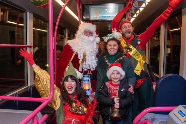 The Mayor arrives on a special Santa Express Foyle Metro bus with Santa and his elves and her grandson Cian. PIcture Martin McKeown. 24.11.23
