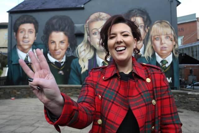 'Derry Girls' creator Lisa McGee beside a mural in honour of the show at Badger's bar next to the Derry Walls.