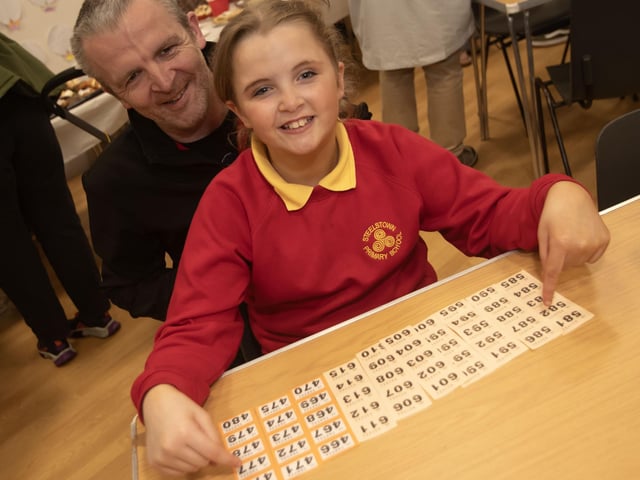 Dad and daughter getting ready for the draw at the Steelstown PS Charity Coffee Morning on Friday.