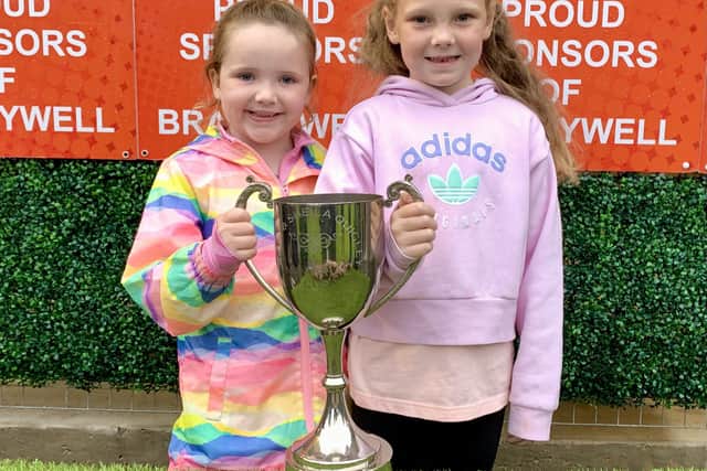 Olivia Bradley (left) & Cadhla McConomy with the perpetual Billy & Sheila Quigley Memorial trophy.