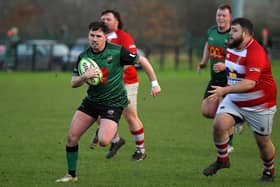 City of Derry’s Jamie Millar fends off a challenge on his way to score a try against Randlestown. Photo: George Sweeney