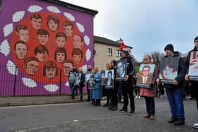 Relatives pass the mural on Westland Street depicting those killed Bloody Sunday. Photo: George Sweeney, DER2205GS – 016