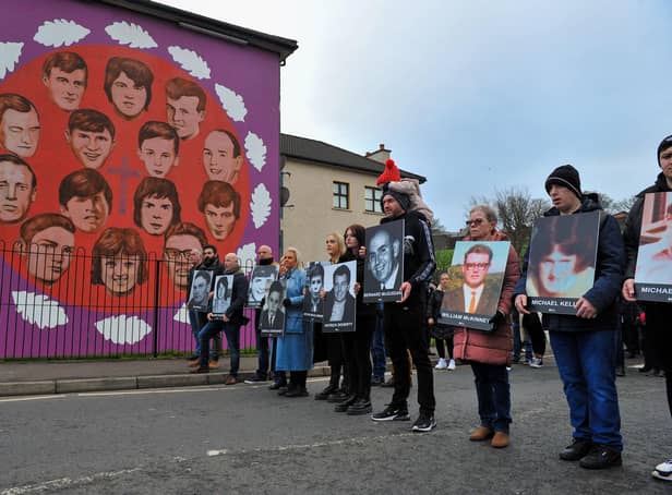 Relatives pass the mural on Westland Street depicting those killed Bloody Sunday. Photo: George Sweeney, DER2205GS – 016