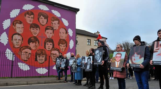 Relatives pass the mural on Westland Street depicting those killed Bloody Sunday. Photo: George Sweeney, DER2205GS – 016