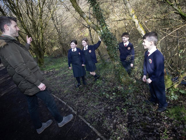 WHICH WAY NOW? . . . Holy Child pupils and their teacher discuss the best way to go during Wednesday's Nature Walk in Creggan Country Park.