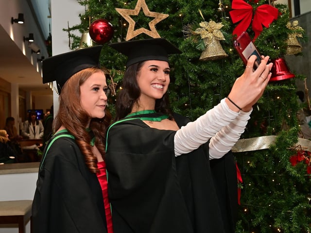 Pacemaker Press 13/12/22From L-R Aine McGarrity from Irvinestown and Aimee Skeffington from Killeeshil ,Who graduated in Nursing at the Ulster University graduation in the Millennium Forum in Derry on Tuesday.Pic  Pacemaker:.
