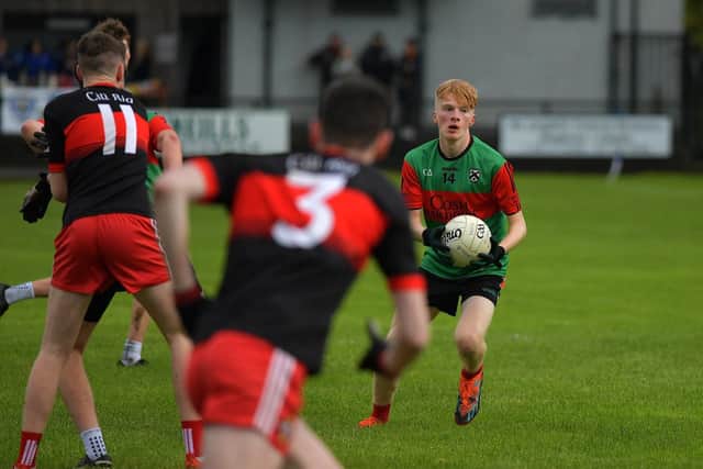 Doire Trasna's Liam Wilson surveys his options as Kilrea ‘s Declan Oliver closes in during Saturday’s Carlin Duffy final at Claudy. Photo: George Sweeney
