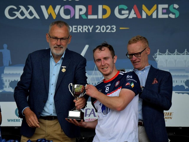 New York captain James Breen receives the GAA World Games Hurling International trophy  from GAA president Larry McCarthy in Celtic Park on Friday morning. Photo: George Sweeney. DER2330GS - 192