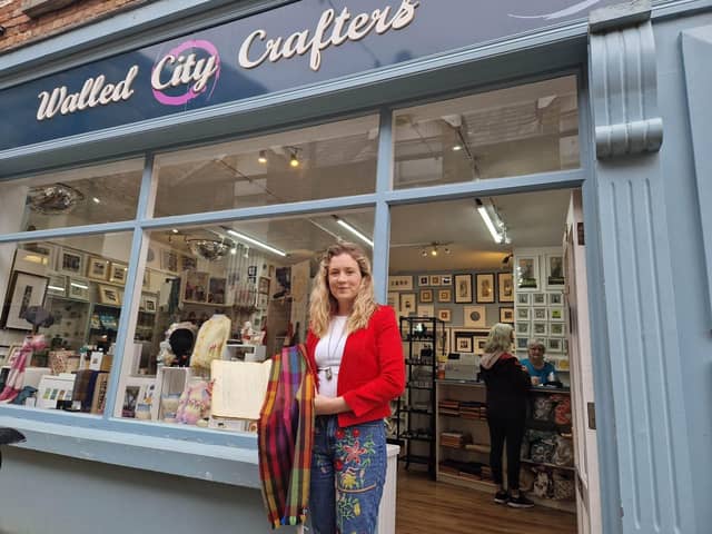 Leona Harkin, pictured outside Walled City Crafters, with her rainbow scarf and the book from Wilkinson's, gifted to her by her grandfather.