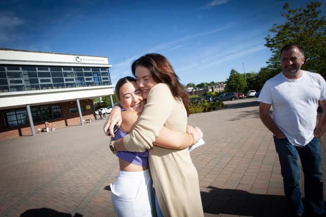 A Level student Aine O'Donnell gets a big hug from mum Ciara after doing well in her exams, at St. Cecilia's College on Thursday morning. (Photos: Jim McCafferty Photography)