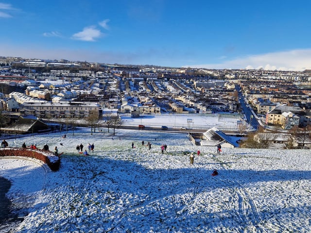 People sleighing on the slopes below Double Bastion.