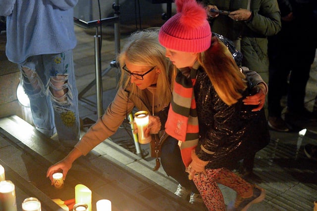 People place candles on the steps of the Guildhall at a vigil held on Monday evening to remember those who died in the Creeslough tragedy on Friday afternoon last.  Photo: George Sweeney.  DER2241GS – 59