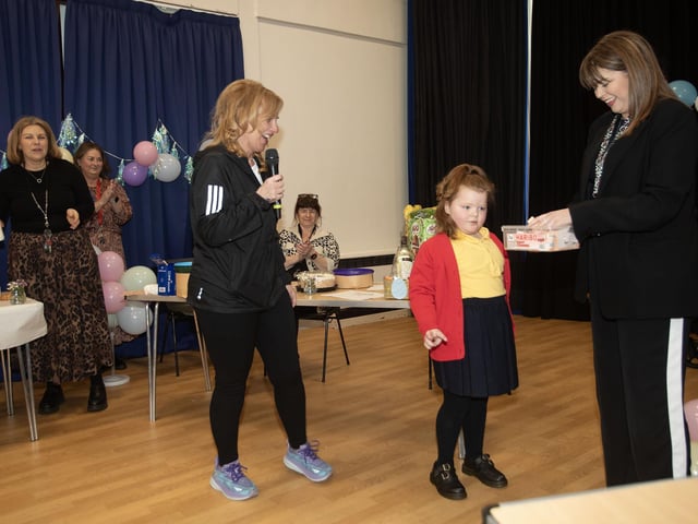 P1 pupil gets ready to draw the first ticket at Friday's Angel Wishes Charity Coffee Morning in Steelstown PS.