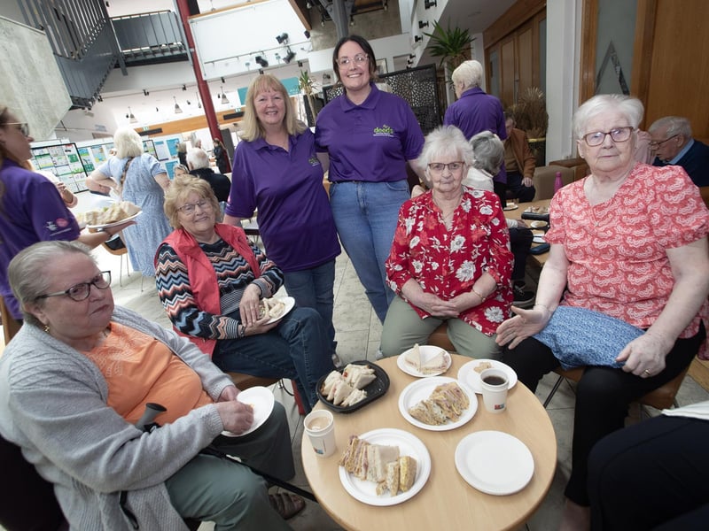 Some guests enjoying tea, coffee and sandwiches.