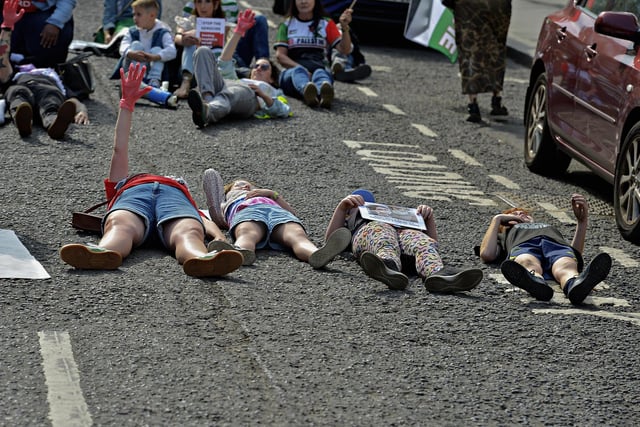 People taking part in a Freedom for Palestine march and rally “lay dead” on Shipquay Street, on Saturday afternoon, highlighting the number of Palestinians who have been killed by Israel.  Photo: George Sweeney