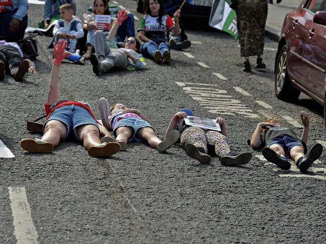 People taking part in a Freedom for Palestine march and rally “lay dead” on Shipquay Street, on Saturday afternoon, highlighting the number of Palestinians who have been killed by Israel.  Photo: George Sweeney