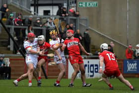 Tyrone and Derry players contest a loose sliothar. Photo: George Sweeney