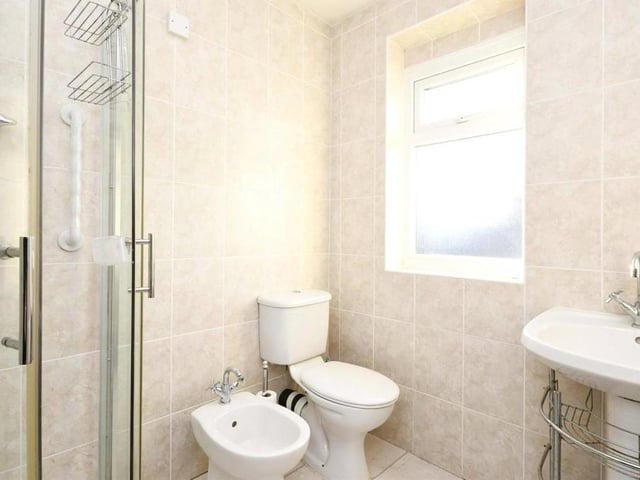 Also on the first floor is this shower room, which comprises shower cubicle, low-flush WC and wash hand basin.