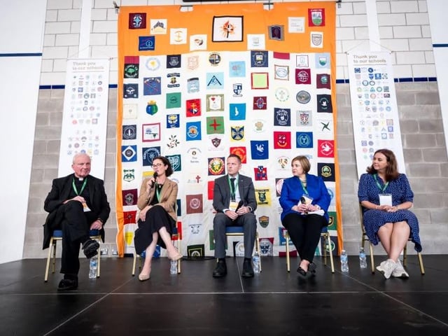 Speakers on stage during the conference.