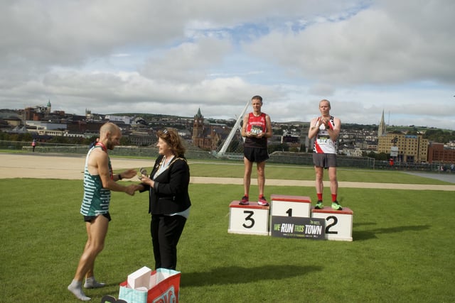 Kyle Doherty (Spartans) receives his winners medal from the Mayor of Derry and Strabane, Councillor Patricia Logue.