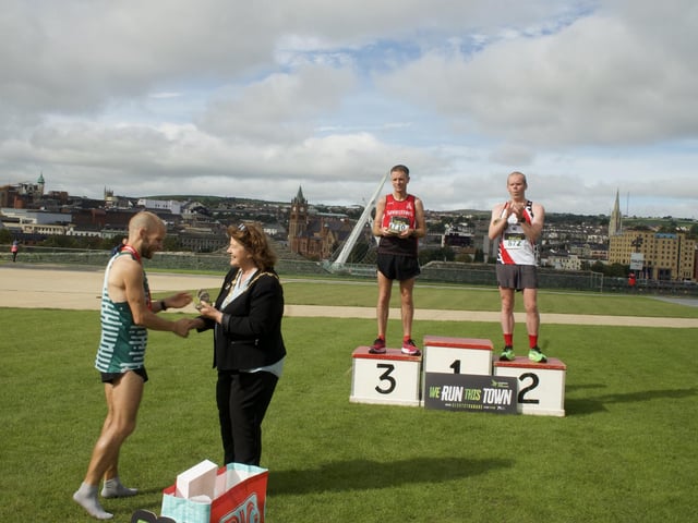 Kyle Doherty (Spartans) receives his winners medal from the Mayor of Derry and Strabane, Councillor Patricia Logue.
