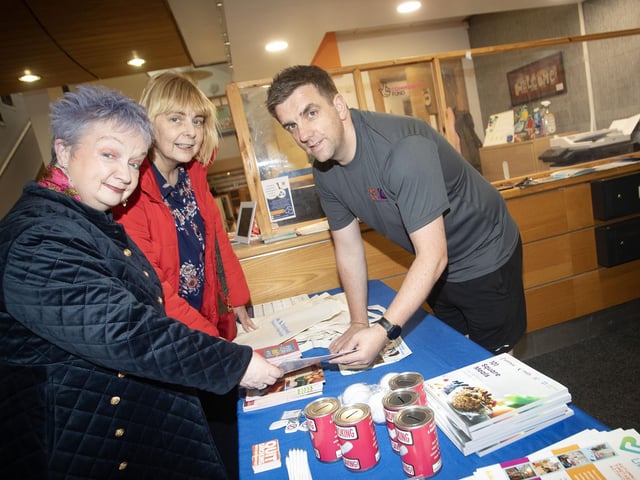 Mo Mahon giving out some leaflets at the Bogside Brandywell Health Forum's stall on Thursday night at the Old Library Trust, Creggan.
