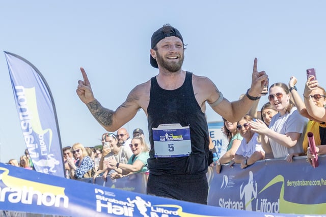 Overall winner Stephen McCauley laps up the applause as he crossed the finish line at Melvin running track.
