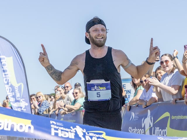 Overall winner Stephen McCauley laps up the applause as he crossed the finish line at Melvin running track.