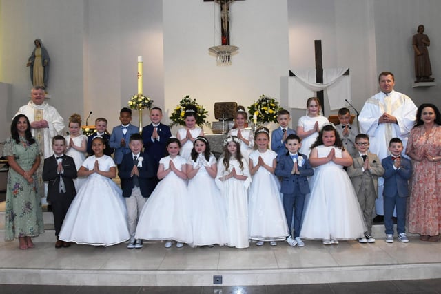 FIRST HOLY COMMUNION . . . . .Pupils from Mrs. McMenamin’s  P4 class at Holy Child PS, Creggan who received the Sacrament of First Holy Communion from Fr. Ignacy and Fr. McFaul at St. Mary's Church on Sunday morning last. Included on left is Ms. Patti Concannon, Principal. (Photos: Jim McCafferty Photography)