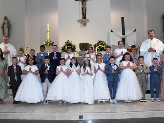 FIRST HOLY COMMUNION . . . . .Pupils from Mrs. McMenamin’s P4 class at Holy Child PS, Creggan who received the Sacrament of First Holy Communion from Fr. Ignacy and Fr. McFaul at St. Mary's Church on Sunday morning last. Included on left is Ms. Patti Concannon, Principal. (Photos: Jim McCafferty Photography)
