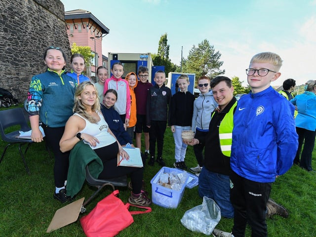 Gaelscoil Eadain Mhoir pupils pictured with Queen’s University archaeologists at the archaeology dig in an area beneath the City Walls. Photo: George Sweeney