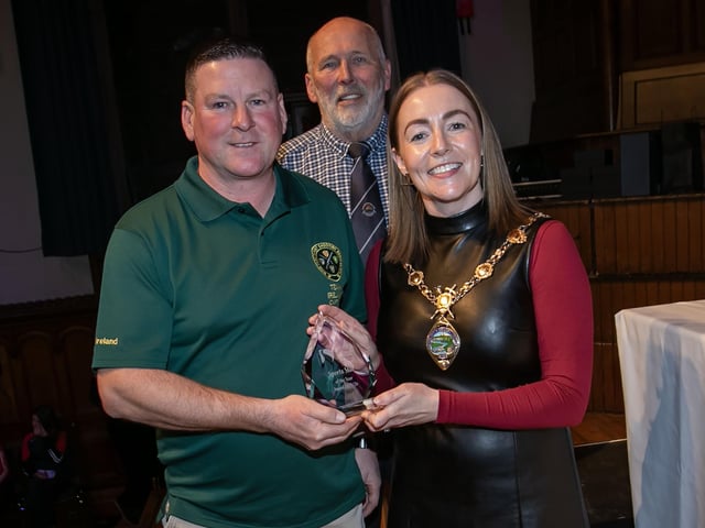 Gareth Warren, winner of the Sports Star award, receiving his trophy from the Mayor, Grace Ui Niallais at the Annual Derry City and Strabane District Sports Awards 2026 in the Guildhall on Thursday night. Back centre is Bill Anderson, Chair, Sports Council,. (Photos: Jim McCafferty Photography)